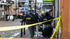 FBI investigators arrive at the scene where the white Ford F-150 pickup truck that crashed into a work lift after allegedly driving into a crowd of New Year's revelers in the French Quarter of New Orleans, Louisiana, on January 1, 2025. - At least 10 people were killed and 30 injured Wednesday when a vehicle plowed overnight into a New year's crowd in the heart of the thriving New Orleans tourist district, authorities in the southern US city said. (Photo by Matthew HINTON / AFP)