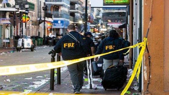 FBI investigators arrive at the scene where the white Ford F-150 pickup truck that crashed into a work lift after allegedly driving into a crowd of New Year's revelers in the French Quarter of New Orleans, Louisiana, on January 1, 2025. - At least 10 people were killed and 30 injured Wednesday when a vehicle plowed overnight into a New year's crowd in the heart of the thriving New Orleans tourist district, authorities in the southern US city said. (Photo by Matthew HINTON / AFP)