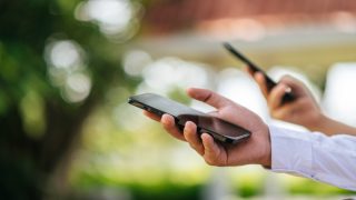 male hand holding a smartphone, selective focus