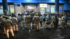Police and emergency workers stand near the emergency building of Calcutta Medical College and Hospitalas relatives of Durga Puja Pandal stampede victims mourn in Kolkata on October 16, 2026. At least 17 people were killed and two dozen more injured on October 17 in eastern India after a stampede that was likely caused by sudden rainfall during a Hindu religious gathering, officials said. (Photo by AFP)